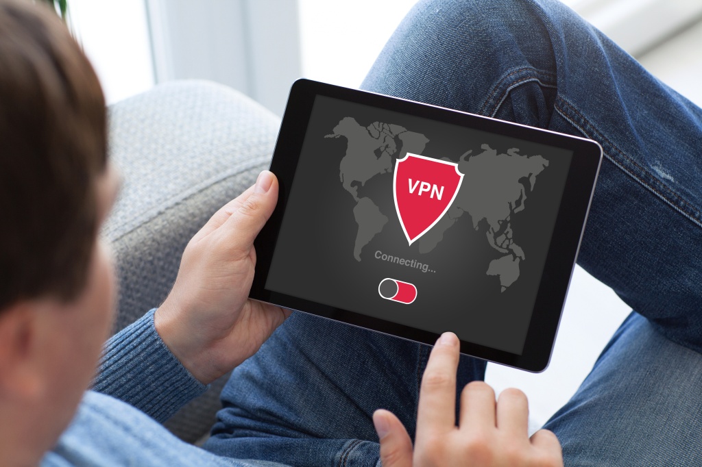مردی که تبلت در دست دارد با برنامه vpn ایجاد پروتکل های اینترنتی برای محافظت از شبکه خصوصی